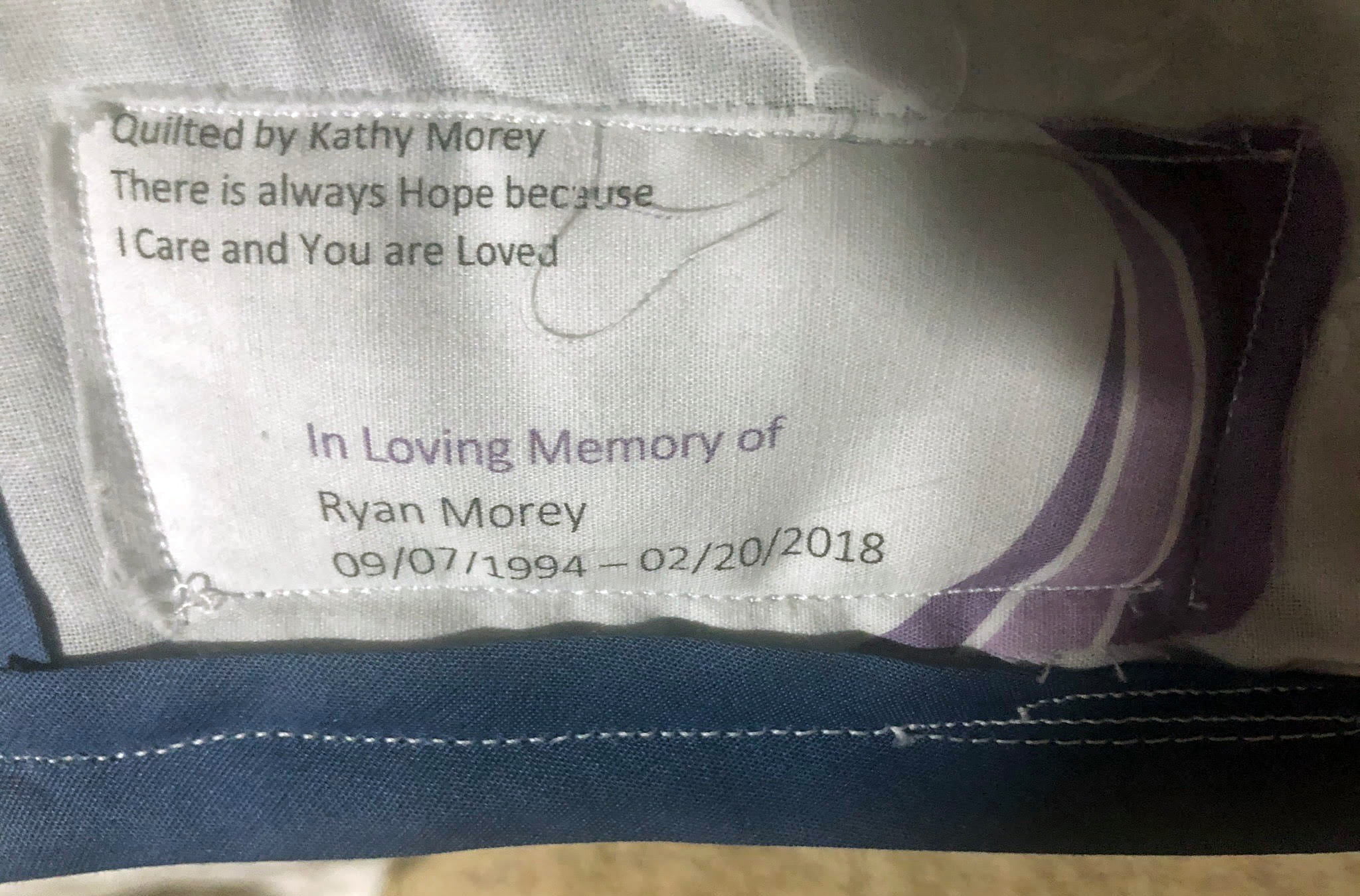 A quilt label displaying who made it and who it was made for