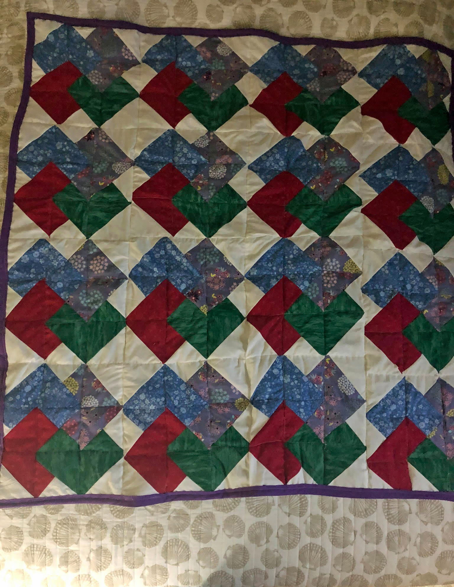 A patterned quilt featuring red, blue and green
