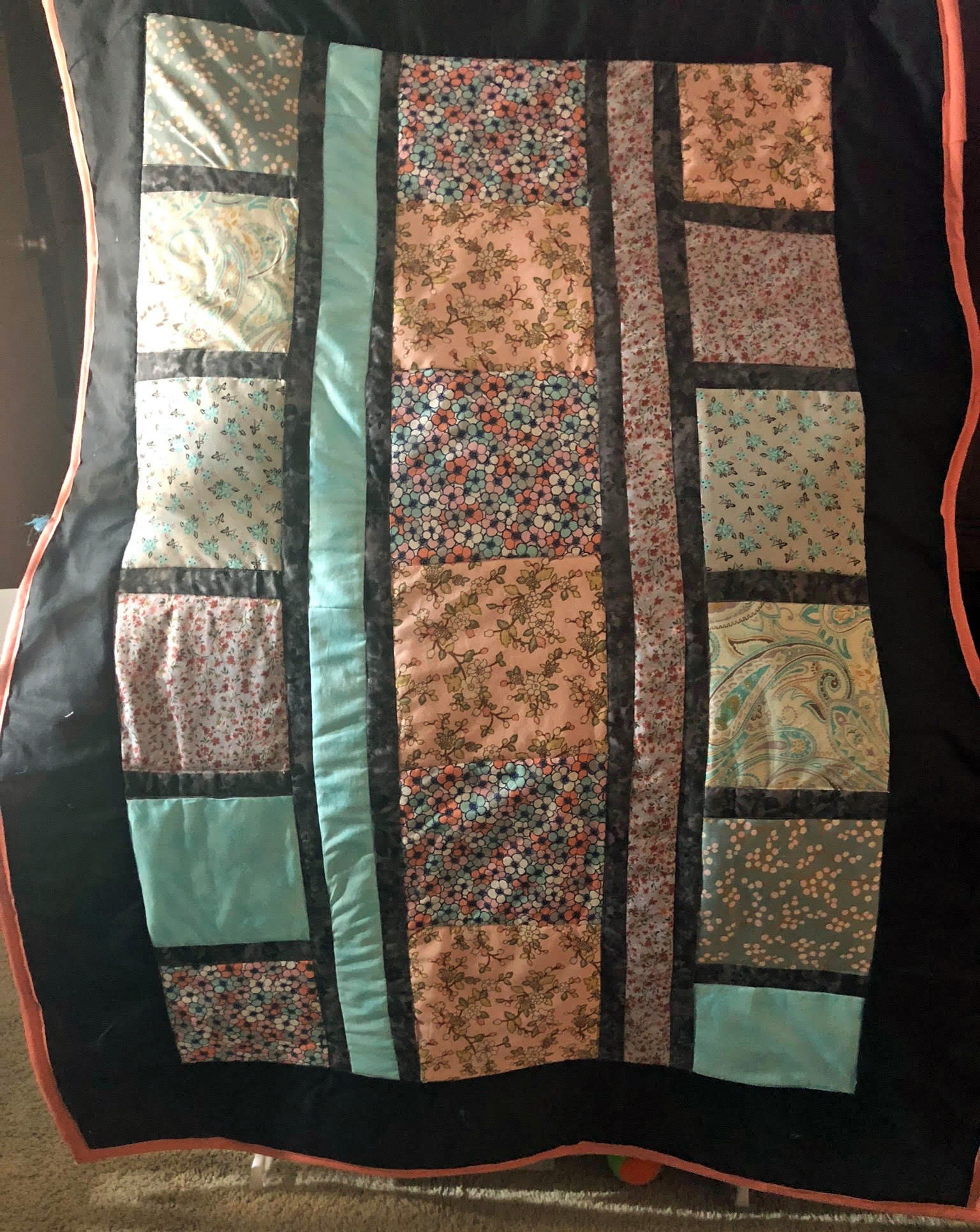 A patterned quilt featuring squares of many colors